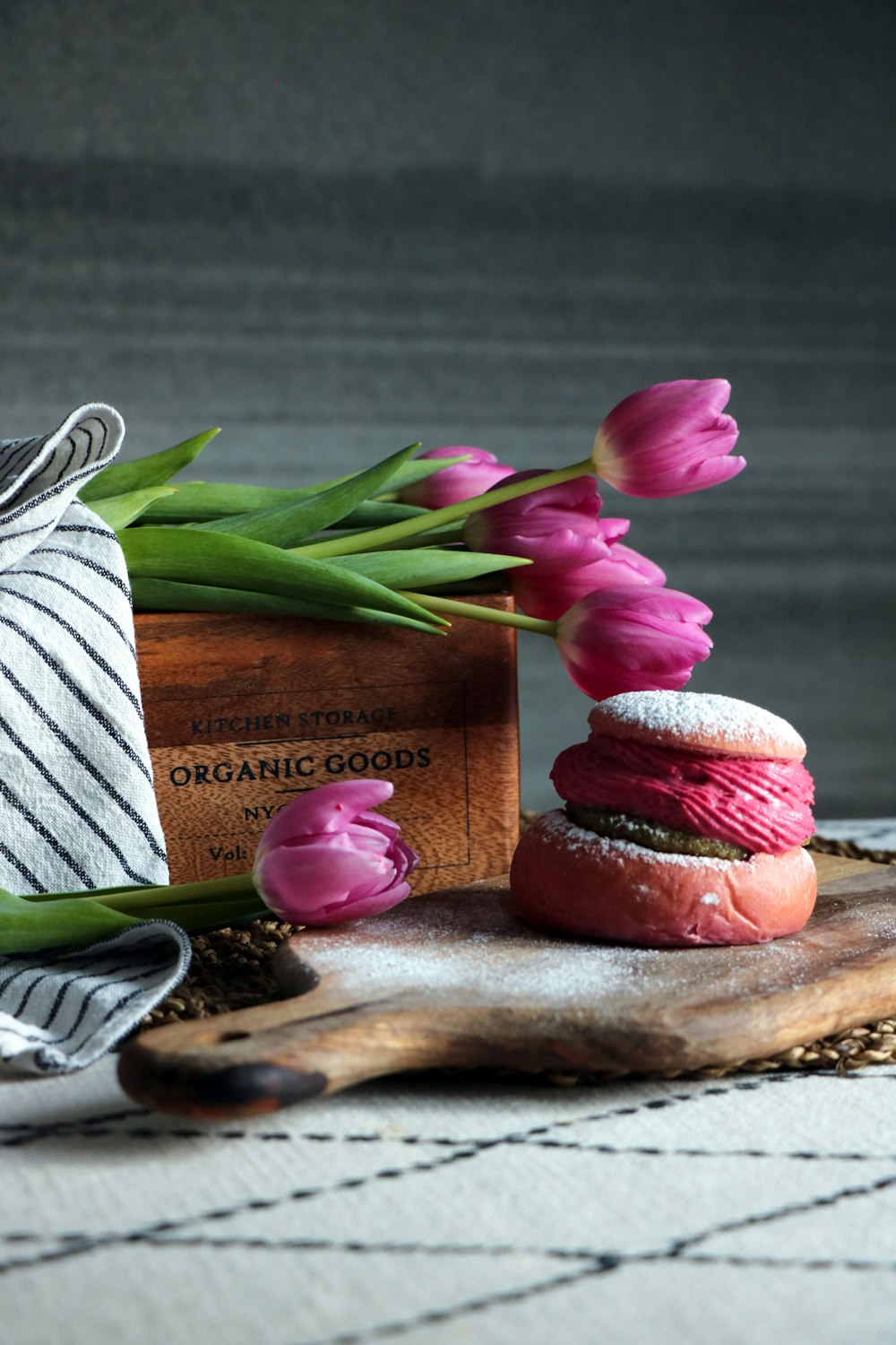 a couple of doughnuts sitting on top of a wooden cutting board