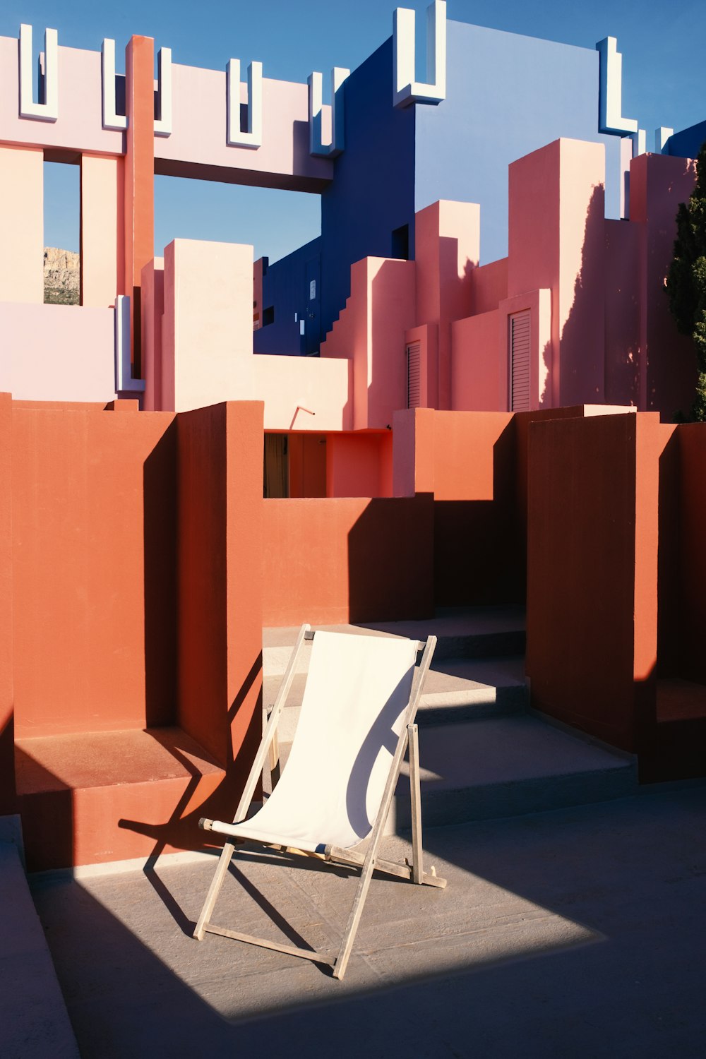 a white lawn chair sitting in front of a building