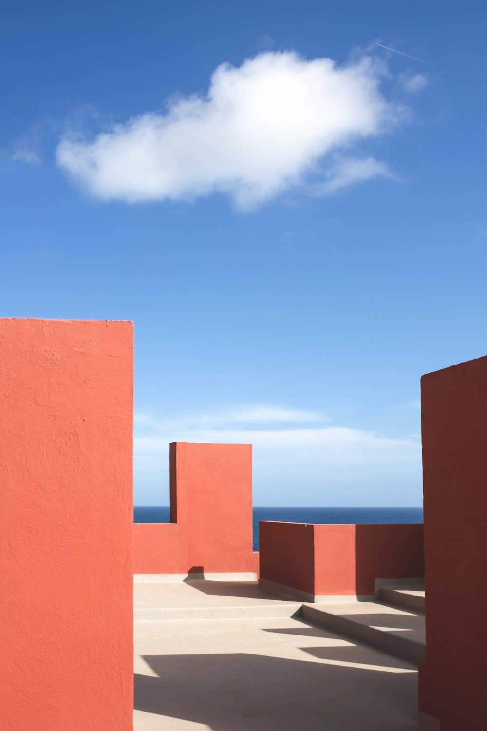 a group of red blocks sitting next to the ocean