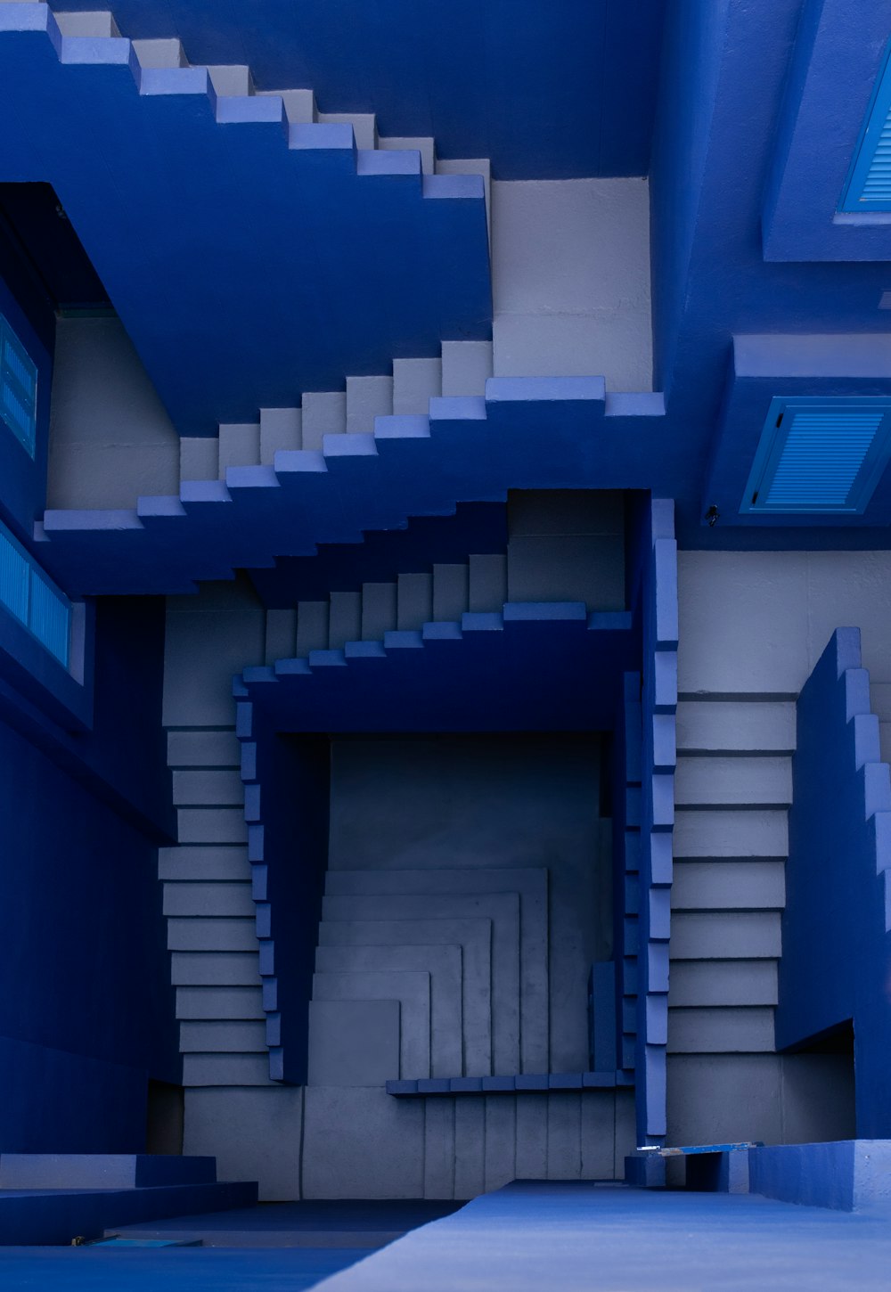 a blue room with stairs and a bench