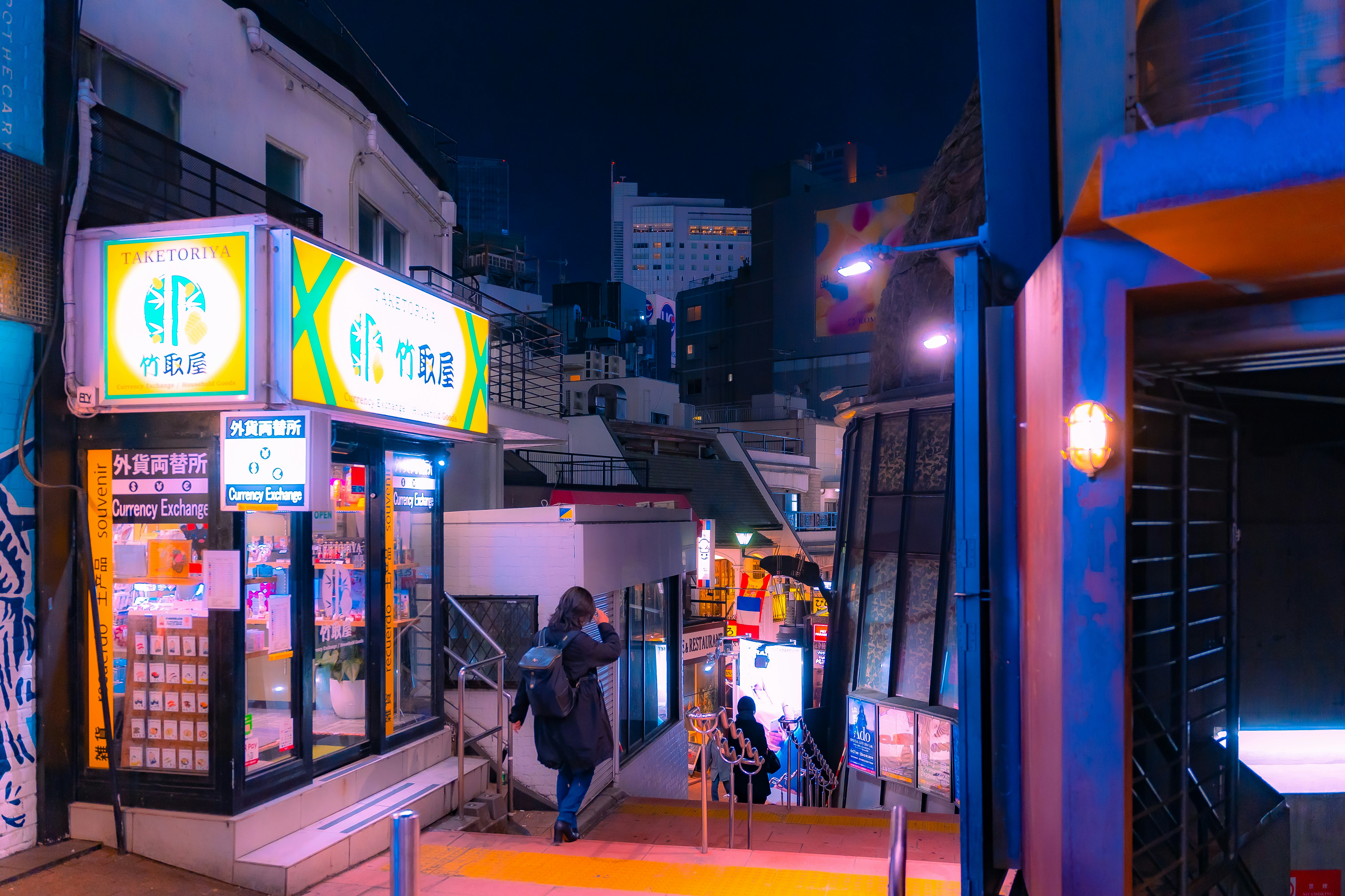 A city street at night with people walking on the sidewalk photo – Free ...