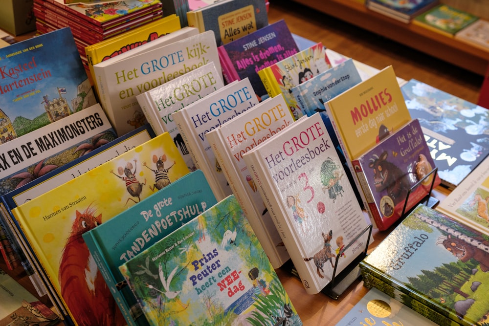 a pile of children's books sitting on top of a table