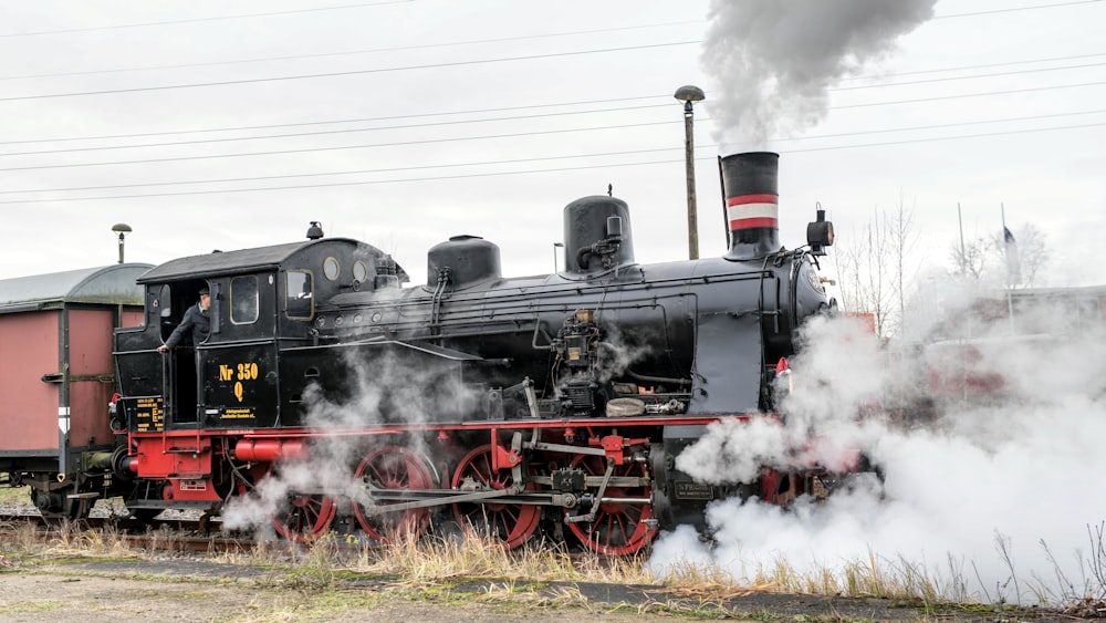 a steam engine train traveling down train tracks