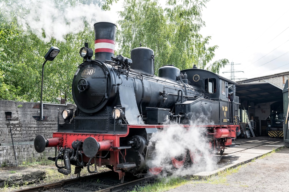 an old fashioned steam engine on a train track