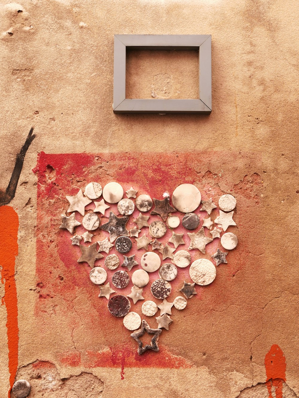 a heart made out of buttons on a wall