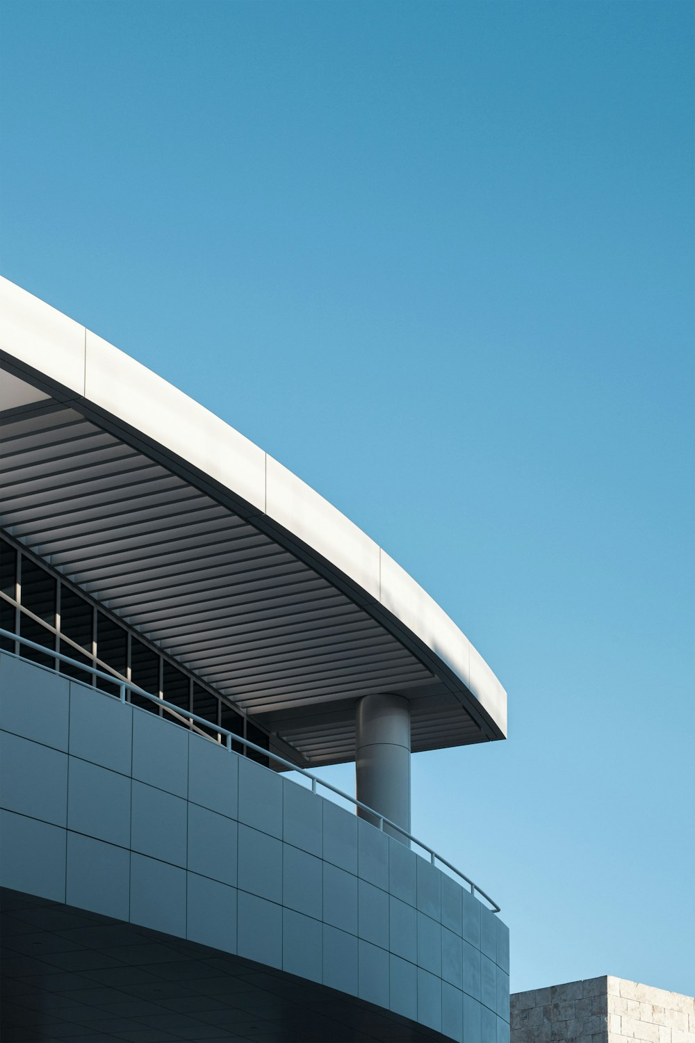 an airplane flying over a building with a sky background