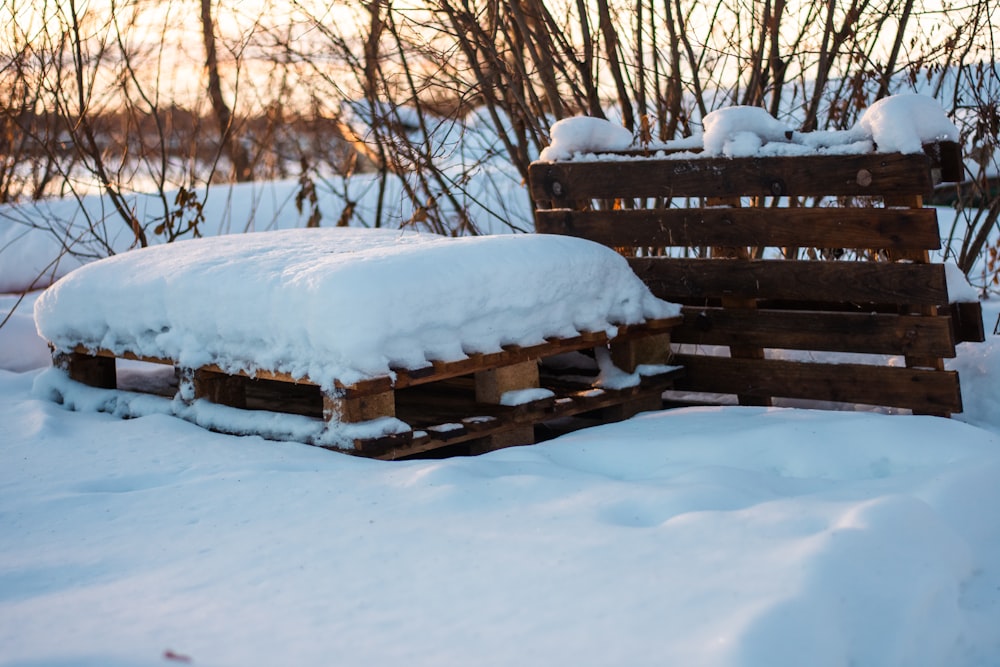 a pile of wooden pallets covered in snow