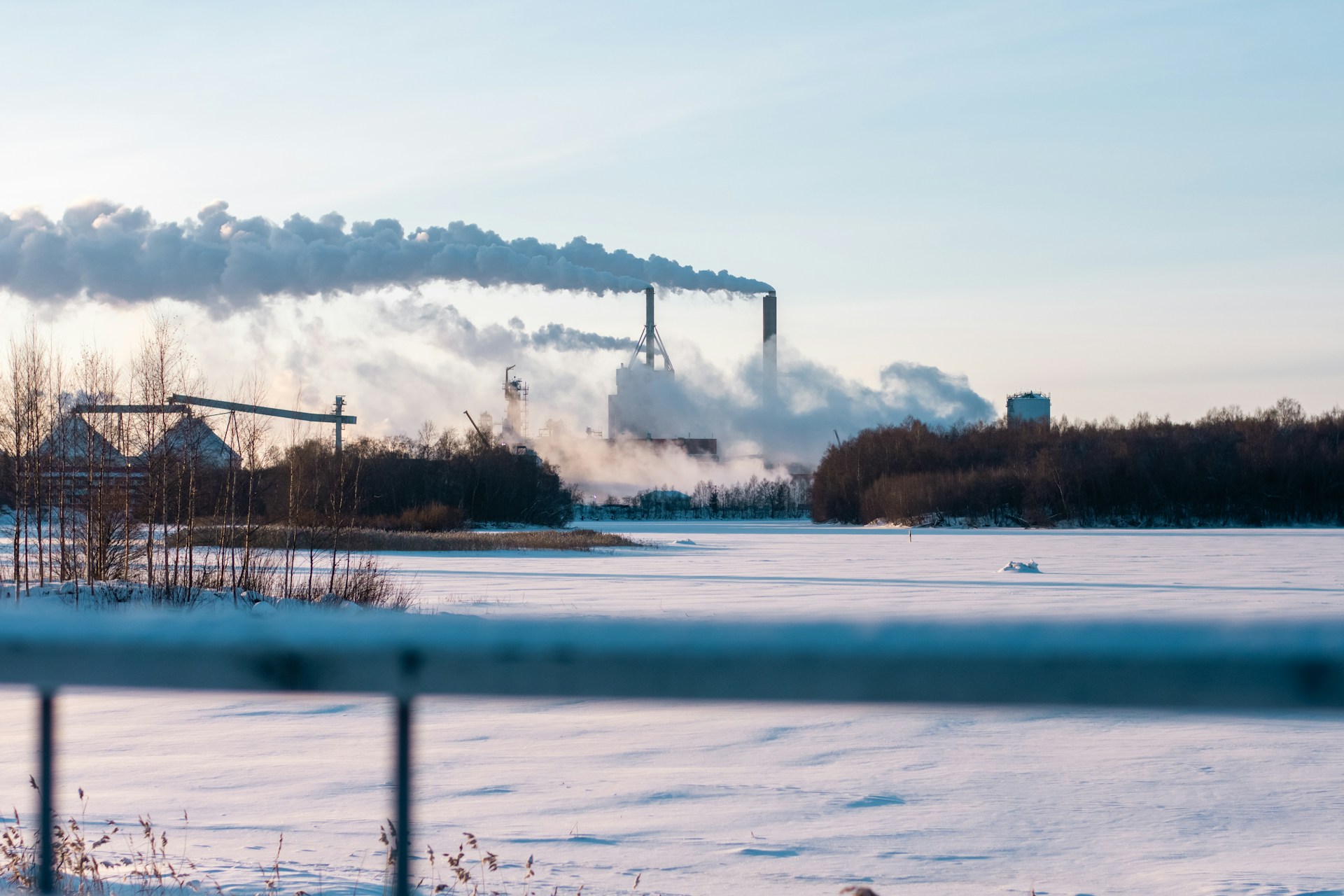 a factory with smoke pouring out of it's stacks