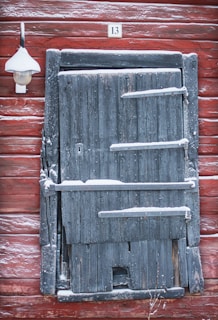 a wooden door with a light on the side of it