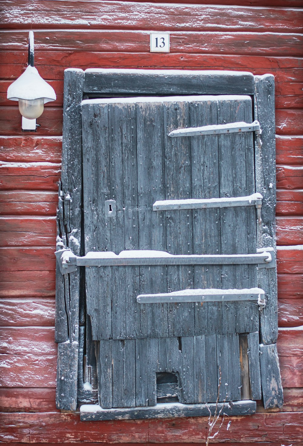 a wooden door with a light on the side of it