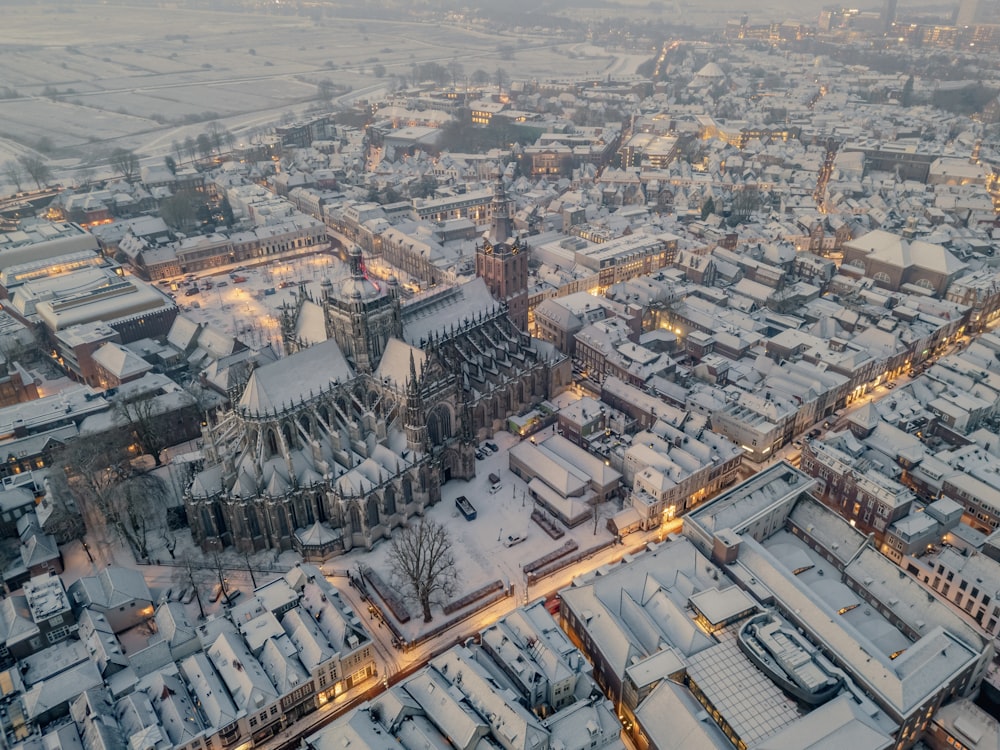 an aerial view of a snowy city at night