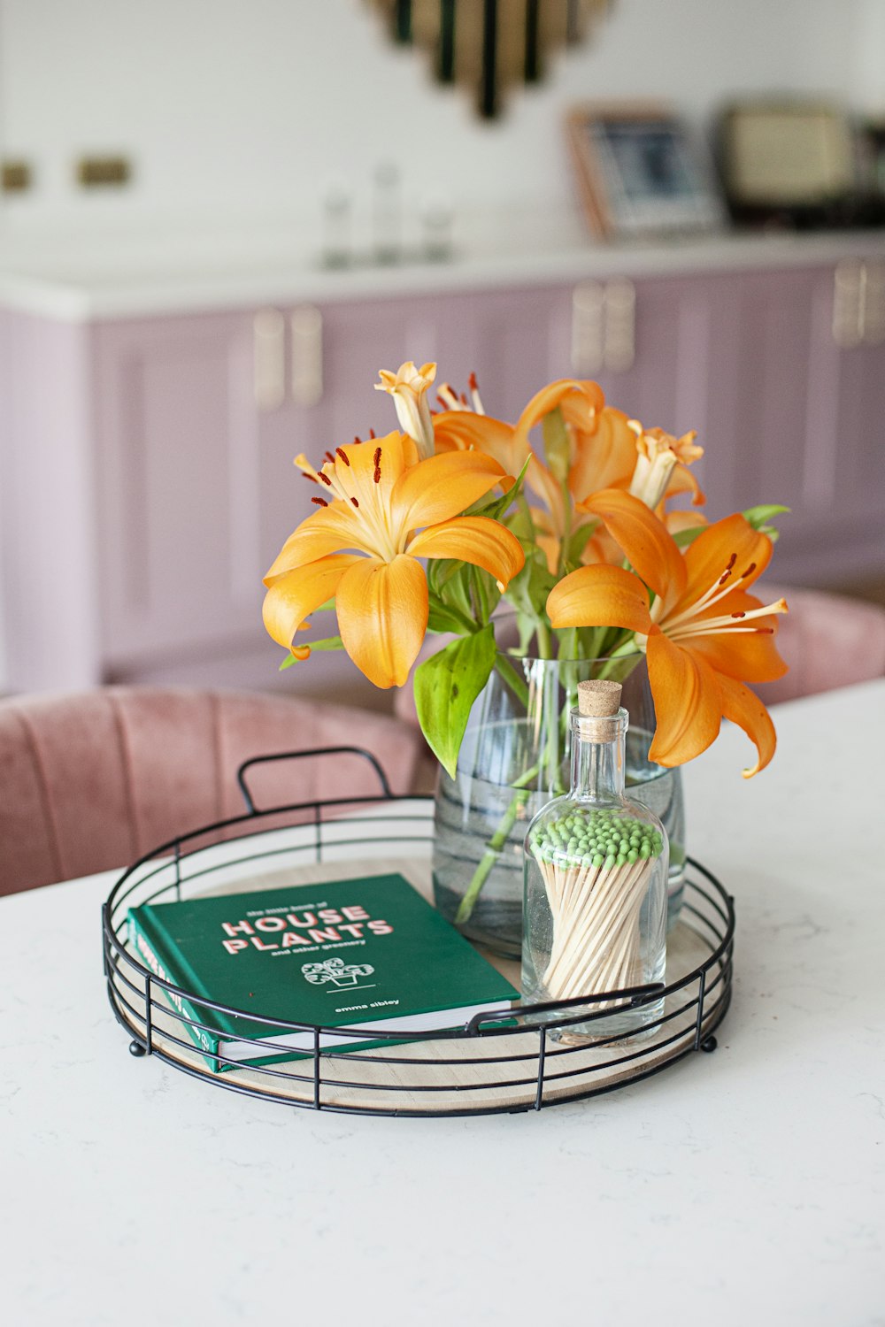 a table with a vase of flowers and a book on it