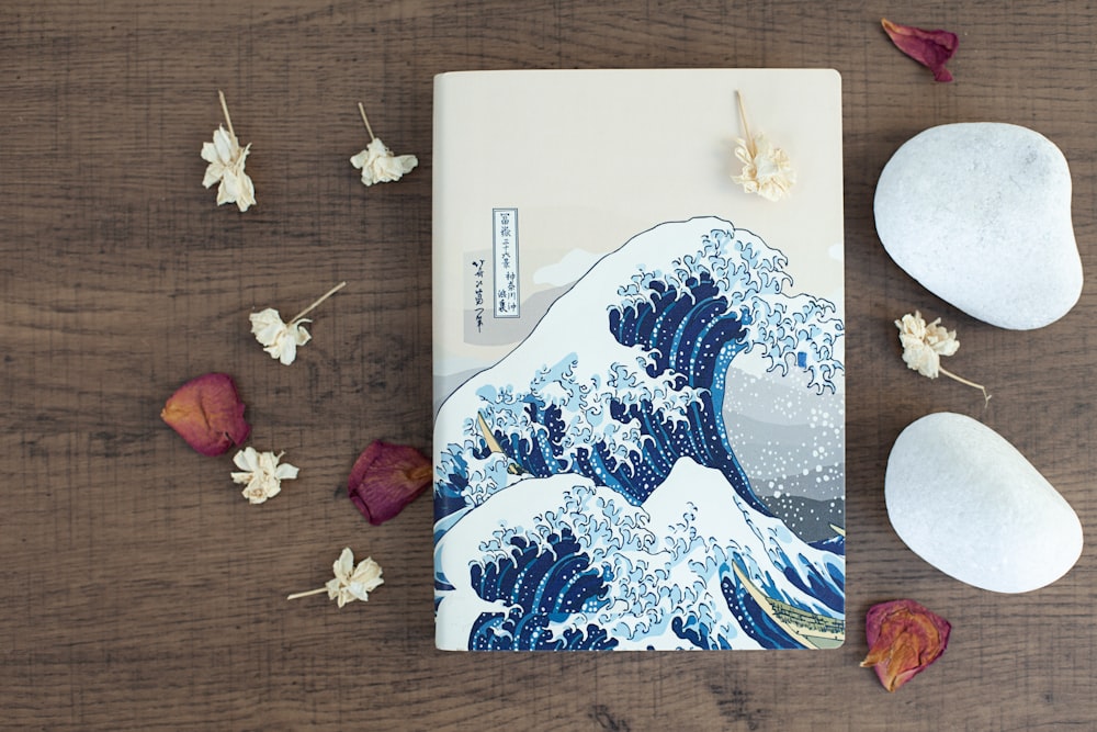 a notebook with a picture of the great wave on it