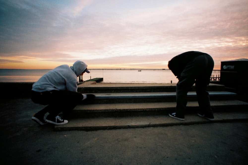 a couple of people that are sitting on some steps