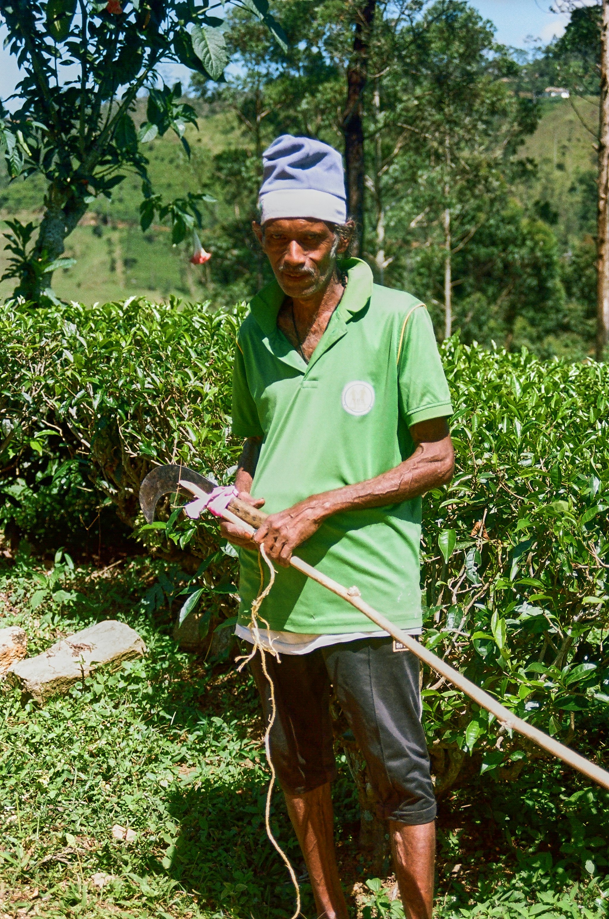 a man in a green shirt is holding a stick