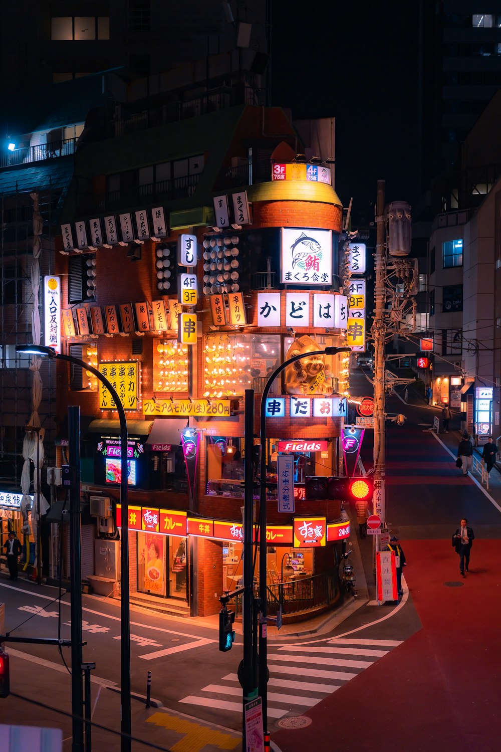 a city street at night with a lot of neon signs