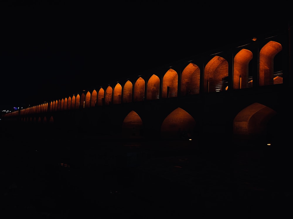 a bridge lit up at night with lights on it