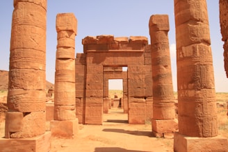 a group of pillars in the middle of a desert