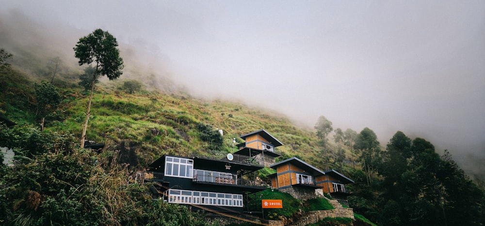 a house sitting on top of a lush green hillside