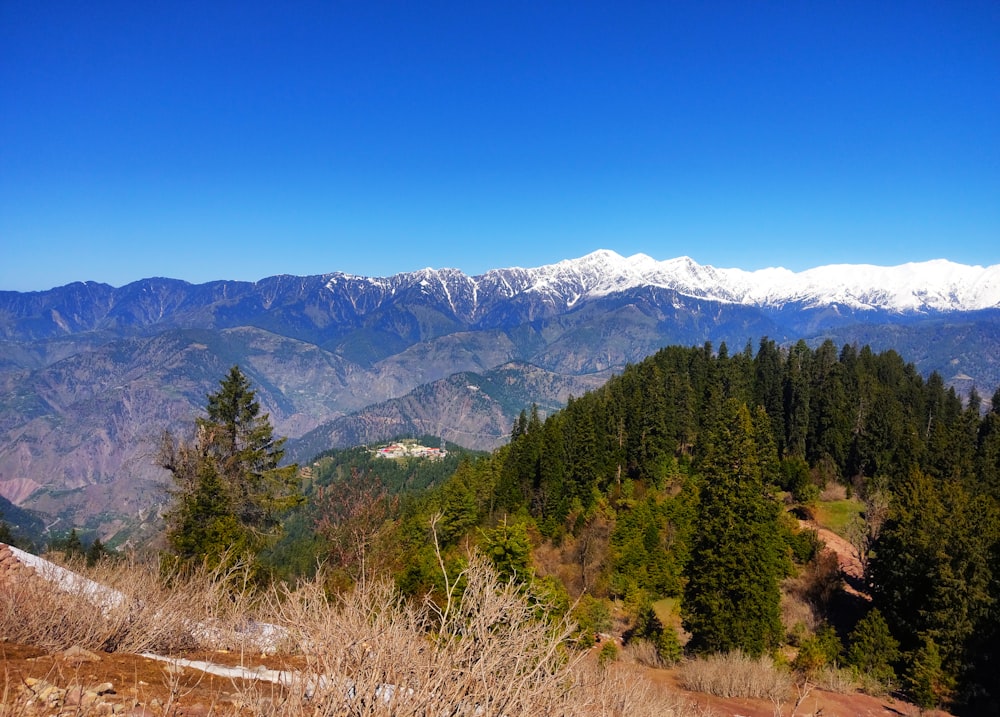 a view of a mountain range with snow capped mountains in the distance