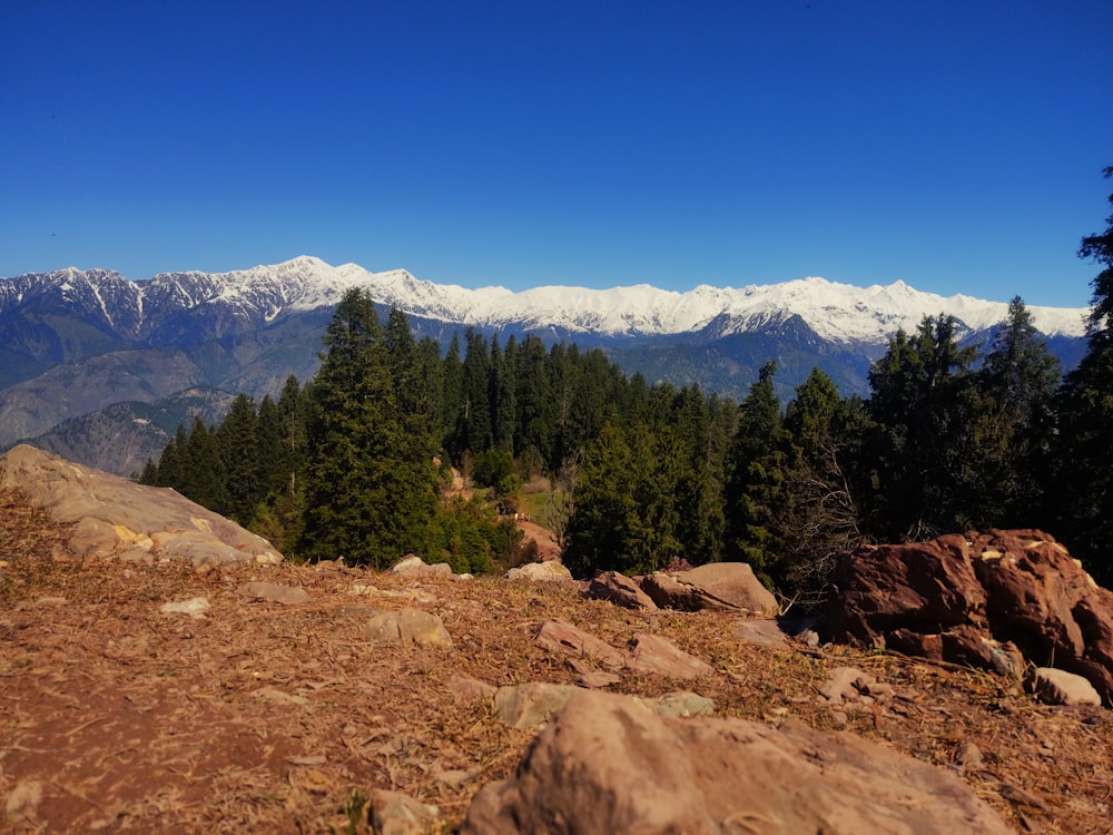 a view of a mountain range with snow capped mountains in the distance