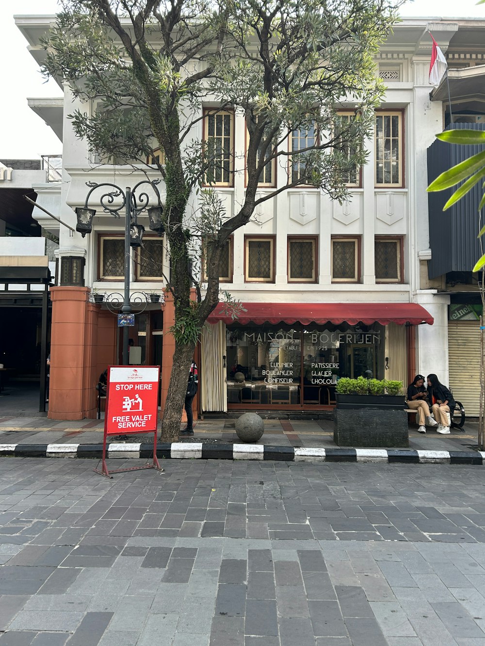 a large white building with a red awning