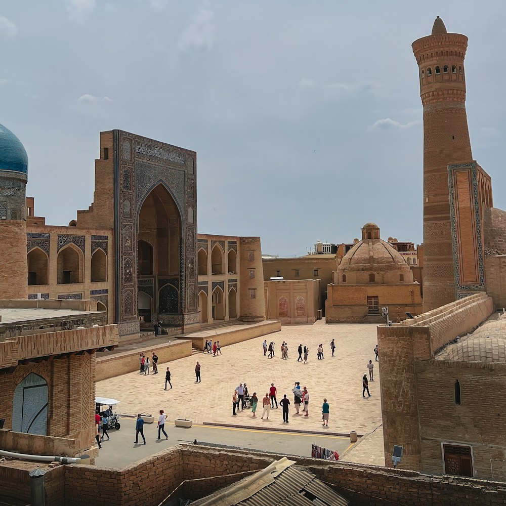 a group of people walking around a courtyard