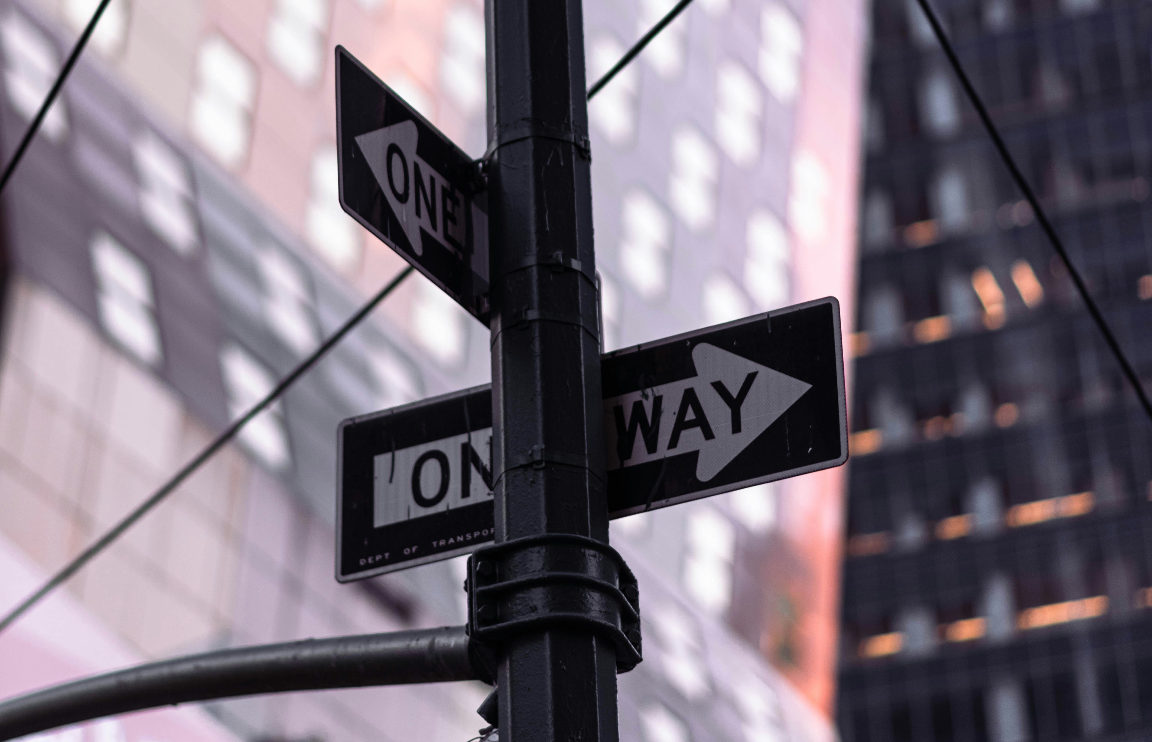 a close up of a street sign with a building in the background