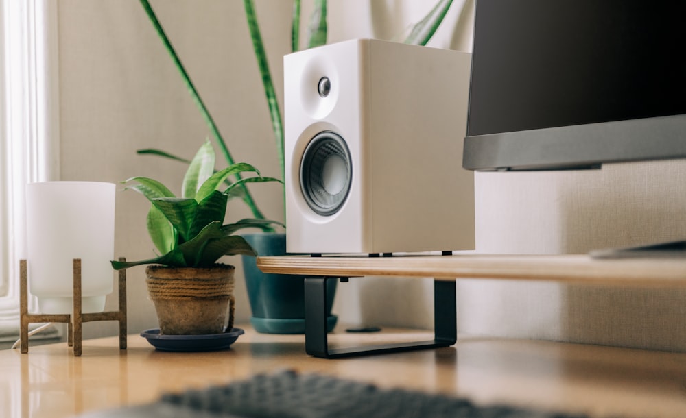 a computer monitor sitting on top of a wooden desk