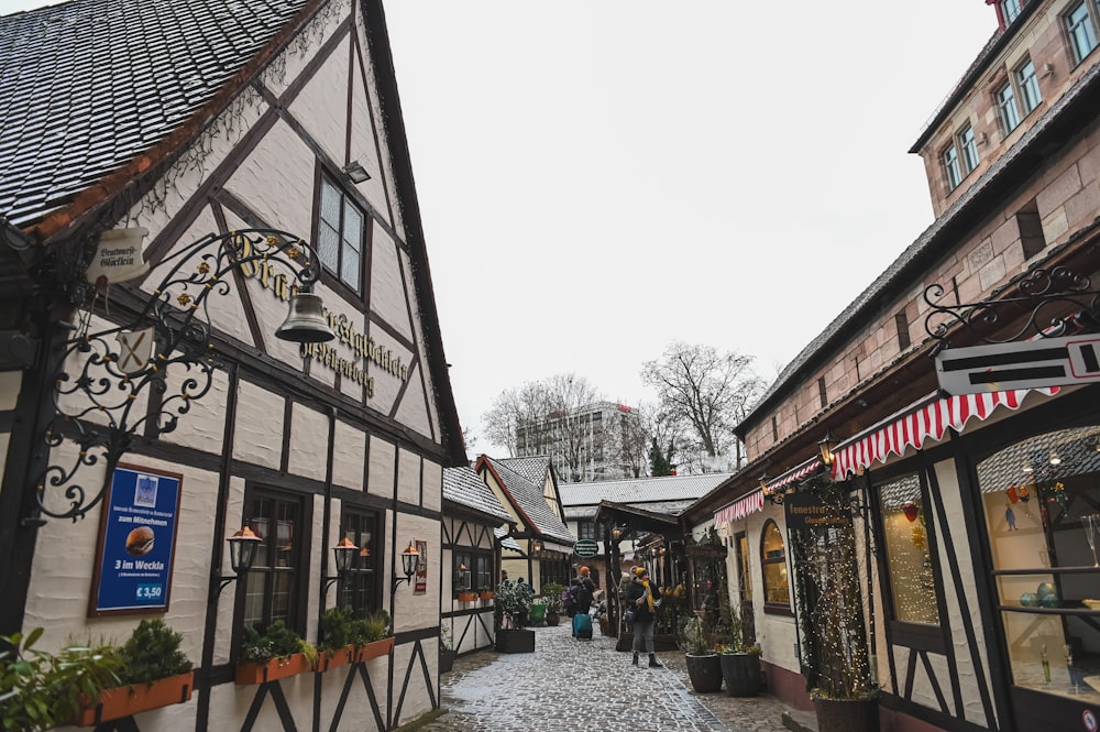 a cobblestone street lined with buildings and shops