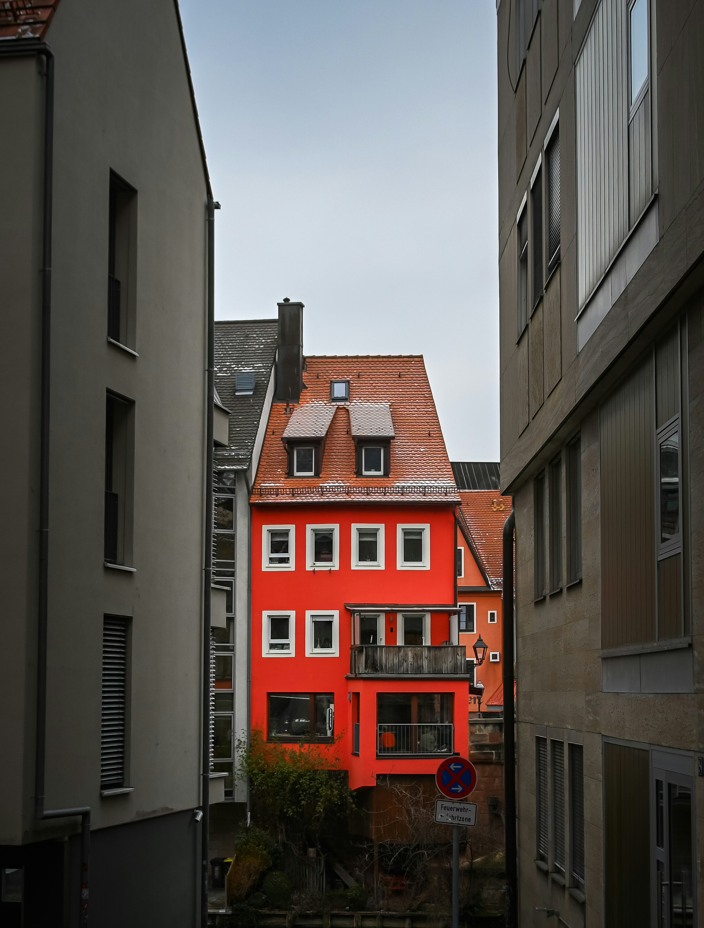 a red building in the middle of a city