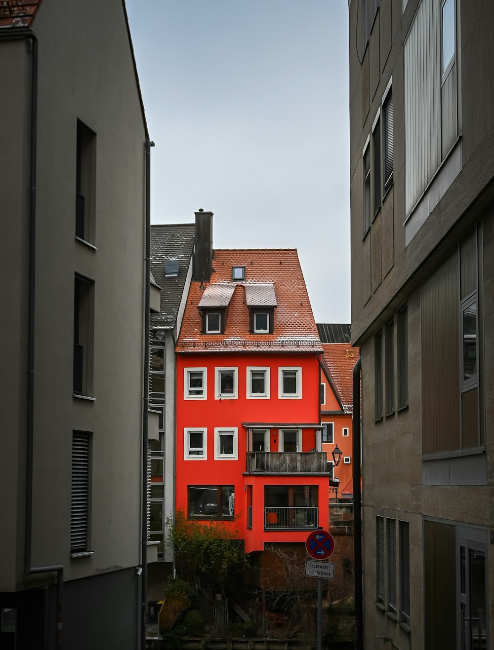 a red building in the middle of a city