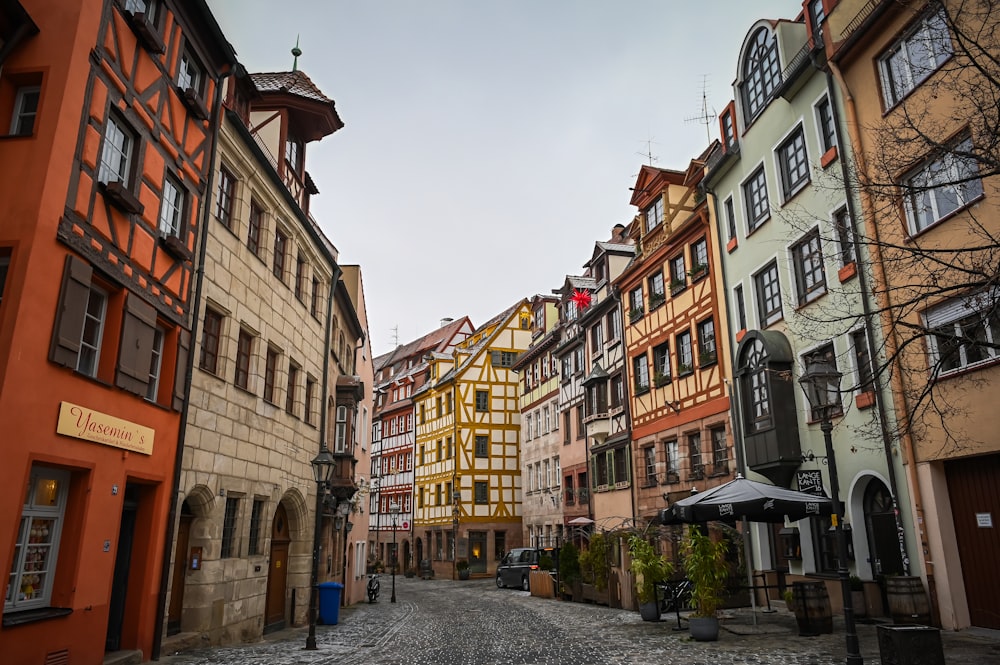 a cobblestone street lined with tall buildings