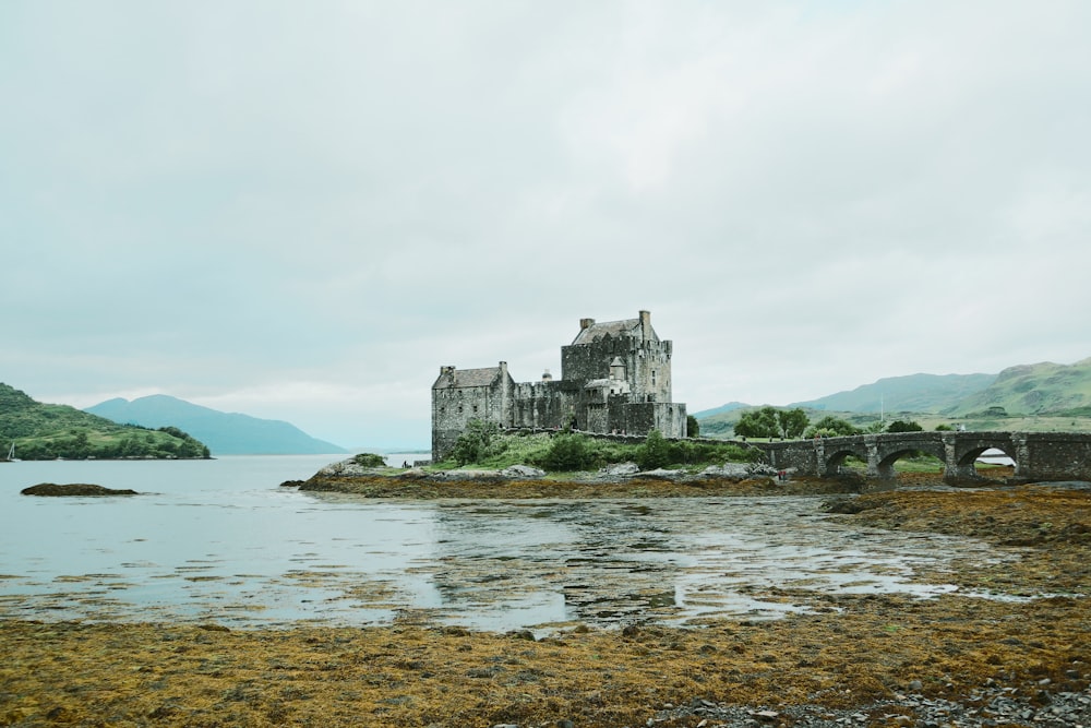 a castle sitting on top of a small island in the middle of a lake