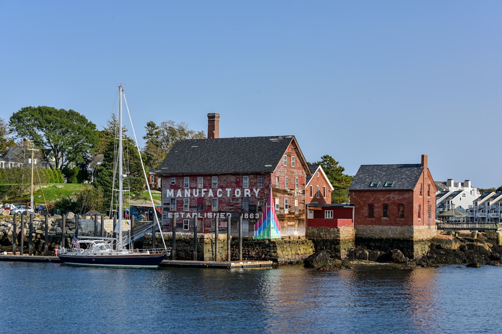 a harbor filled with lots of boats next to a red brick building