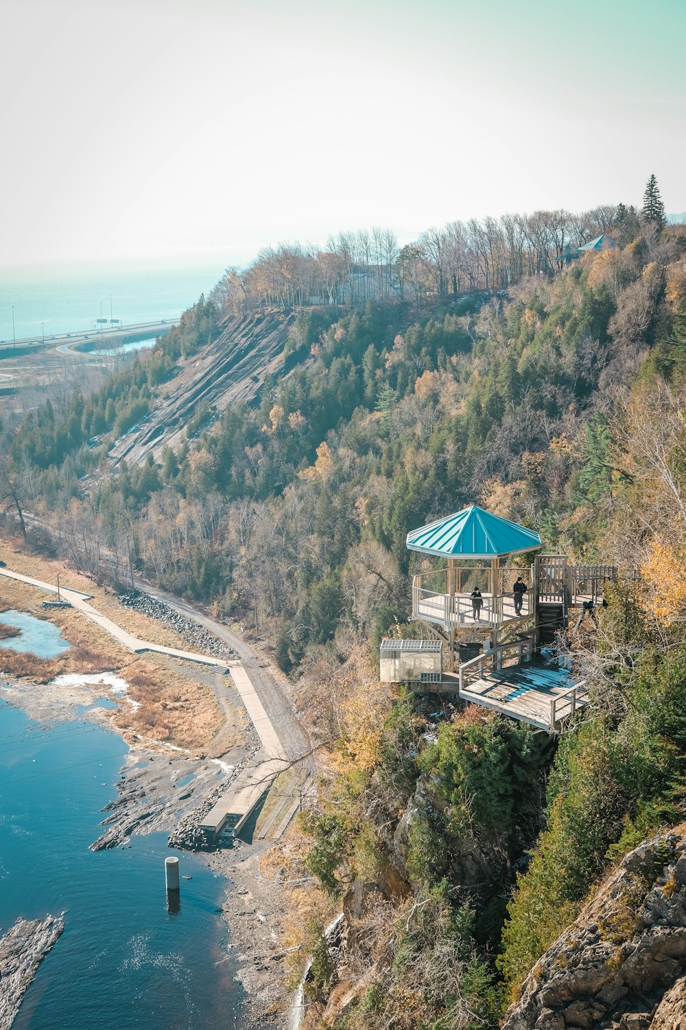 a gazebo sitting on top of a cliff next to a body of water