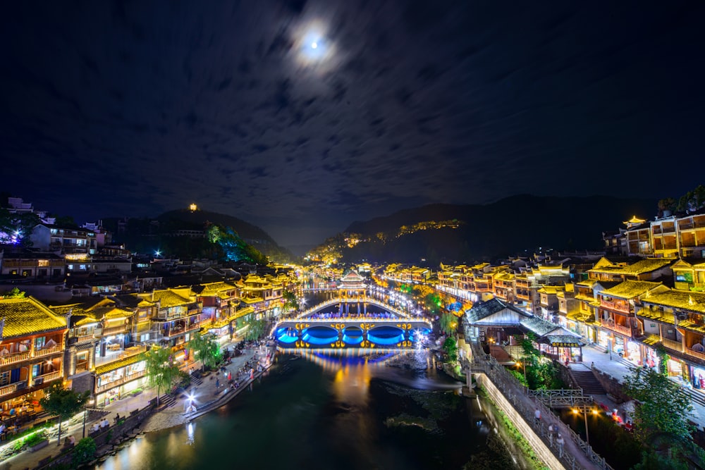 a night view of a city with a river running through it