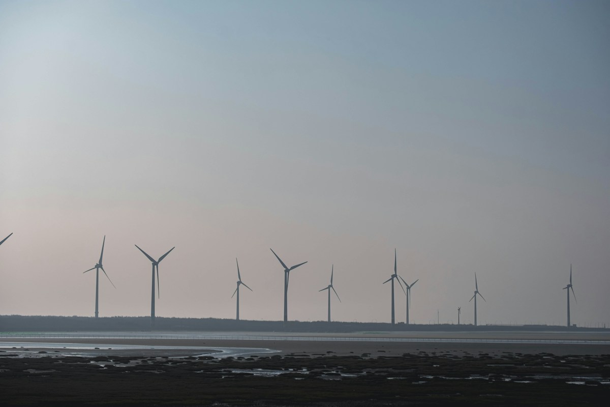 Mudflats and a long row of wind turbines at Gaomei Wetlands in Qingshui, Taichung
