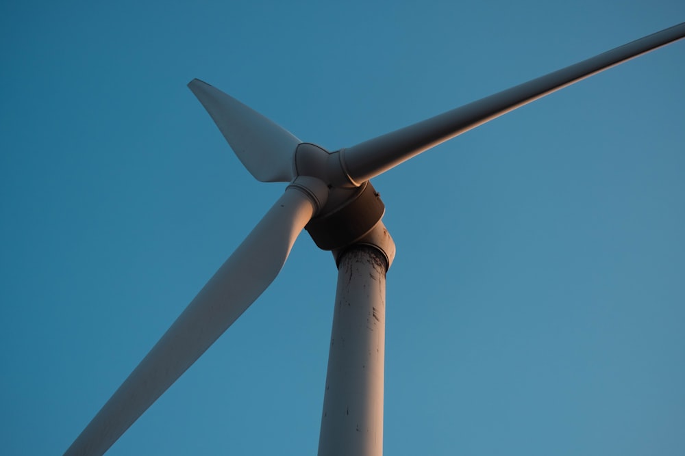 a close up of a wind turbine against a blue sky