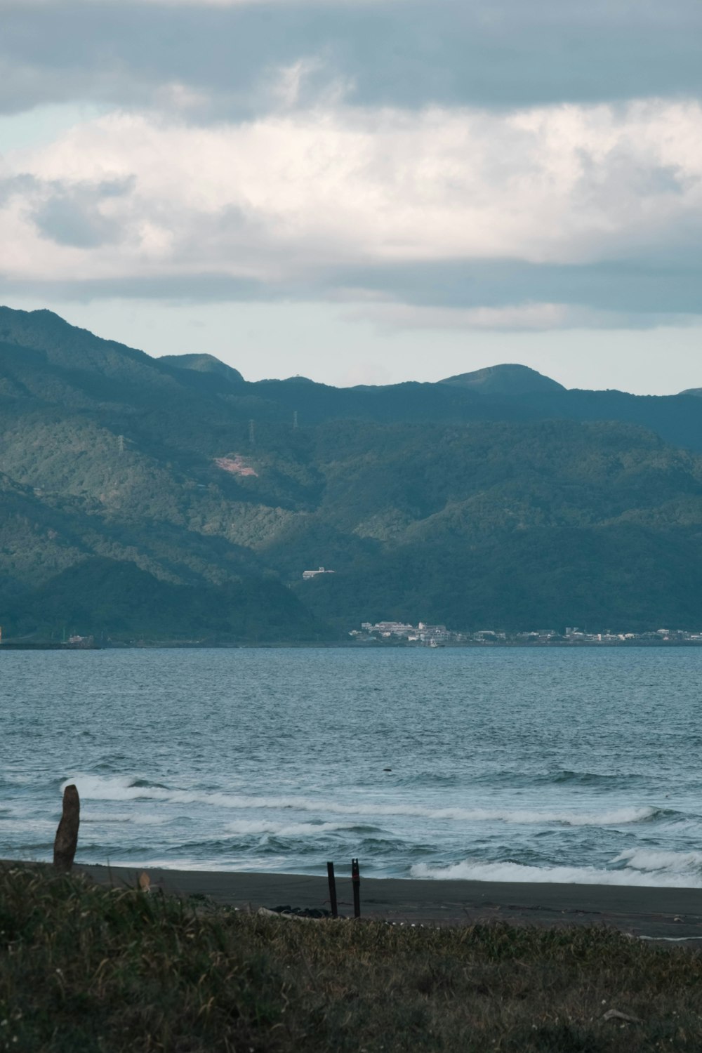 a body of water with mountains in the background