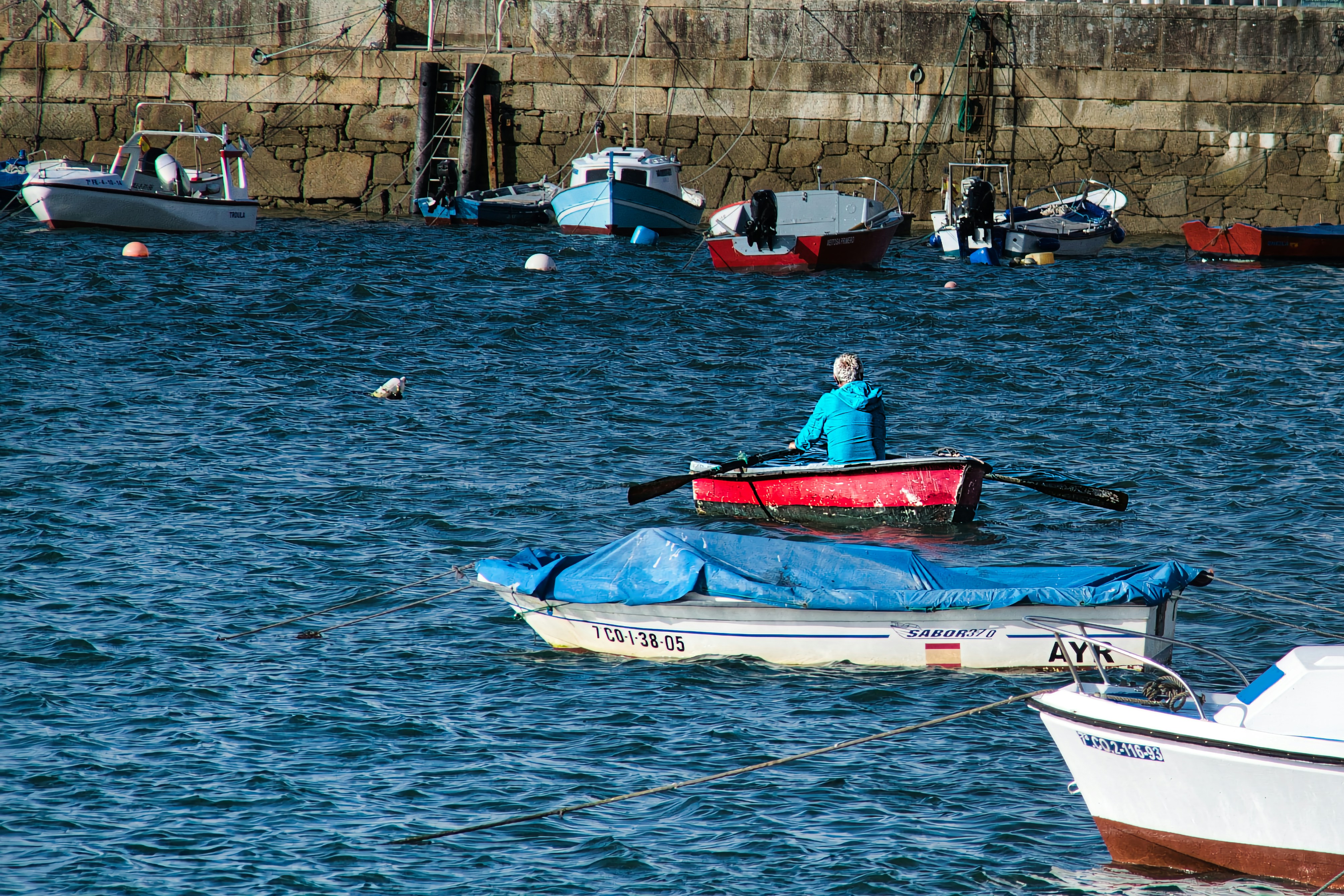 a person in a red and white boat in the water