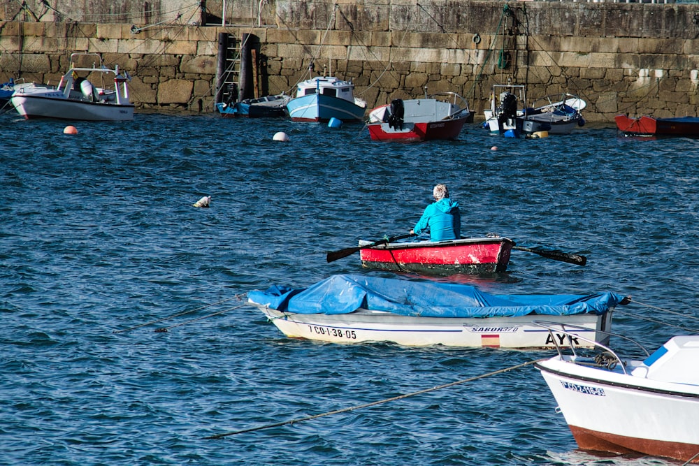 a person in a red and white boat in the water