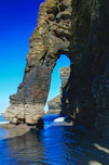 a large rock formation in the middle of a body of water