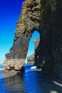 a large rock formation in the middle of a body of water