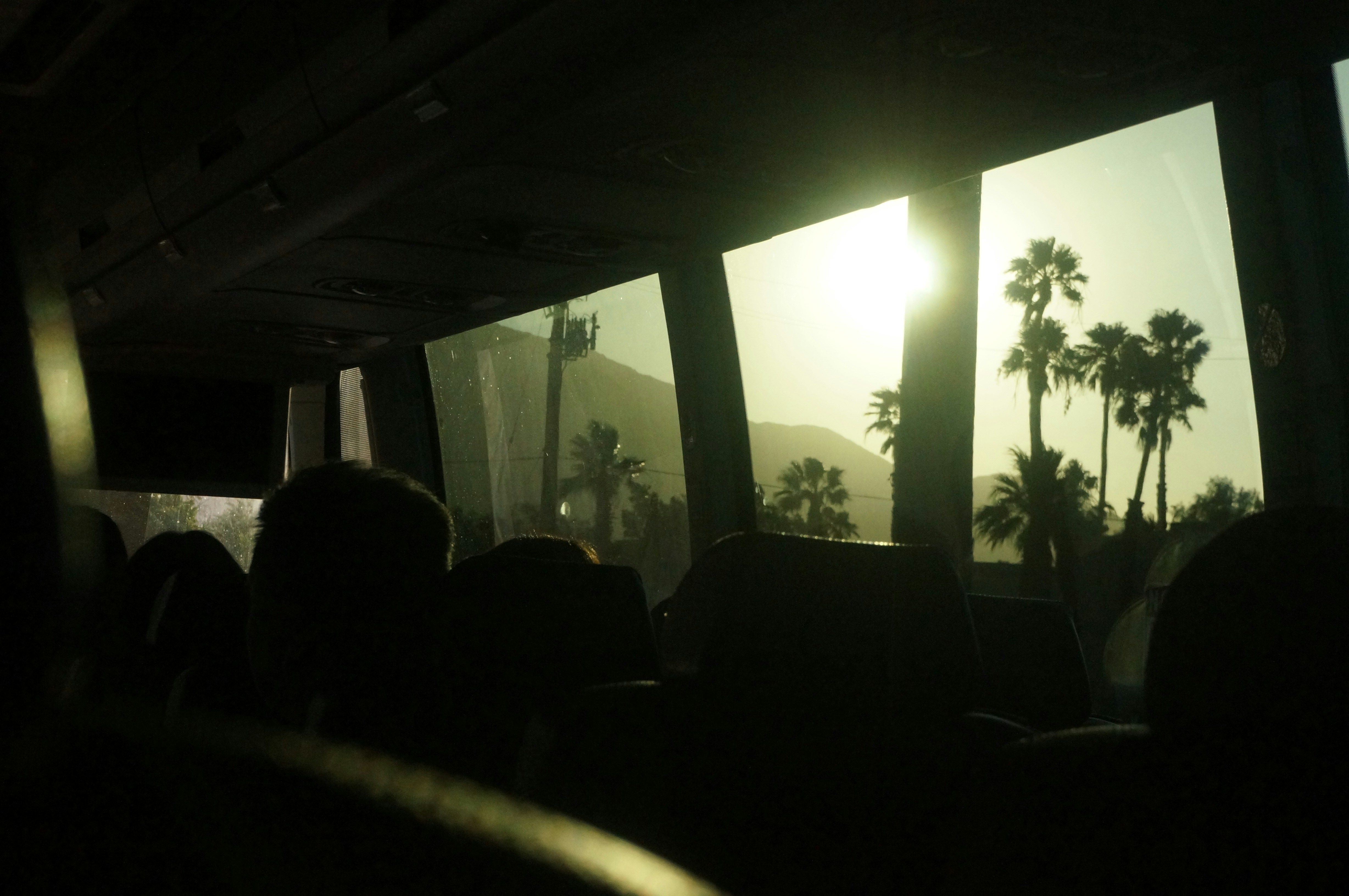 a group of people sitting in front of a window, 
