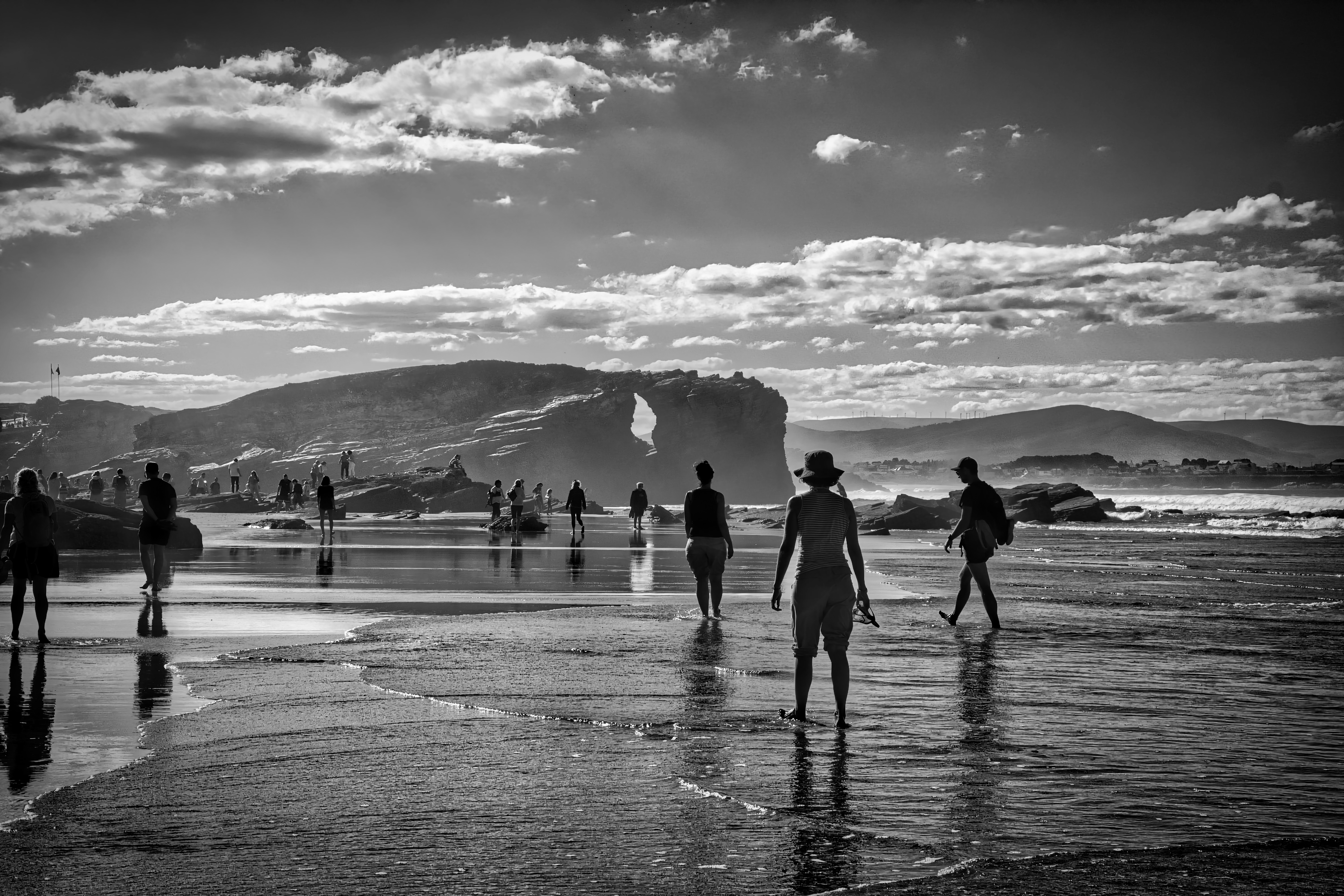 a group of people standing on top of a beach