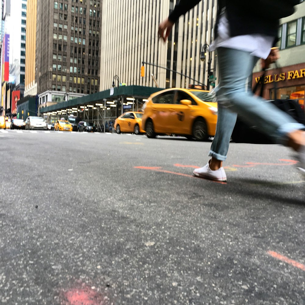 a man riding a skateboard down a street next to tall buildings