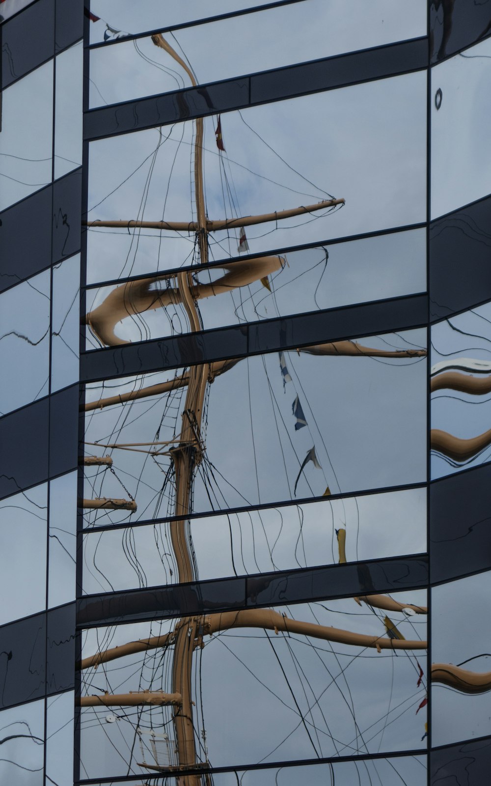 a reflection of a ship in a building's windows
