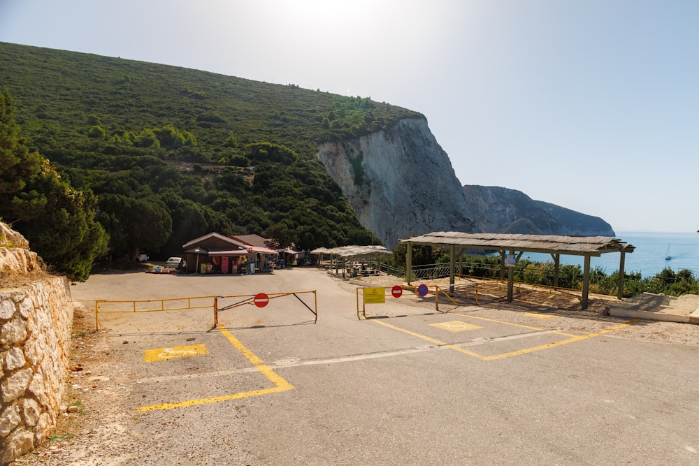 a parking lot next to a mountain with a volleyball court