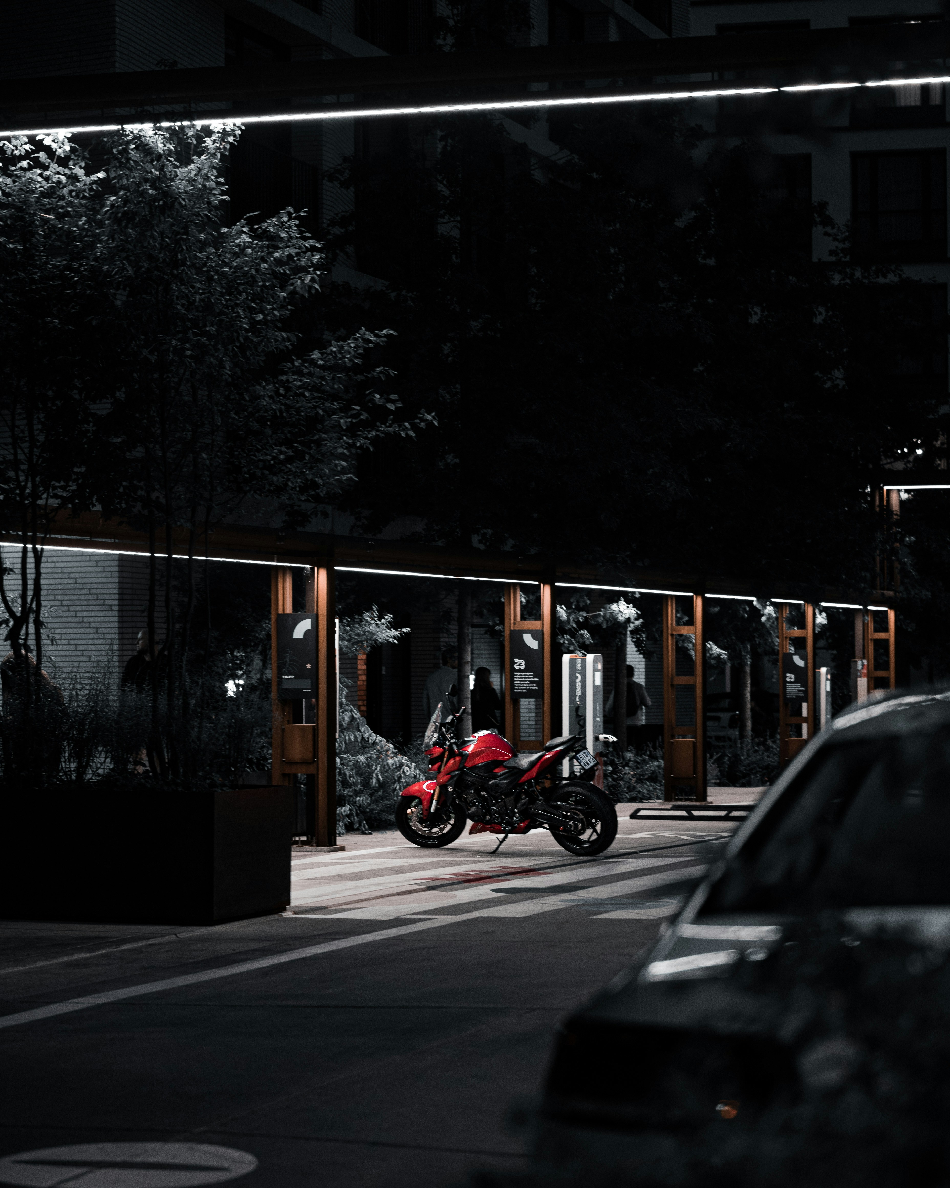 a motorcycle parked in a parking lot at night